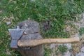 an ax with a wooden handle lies on a wooden block Royalty Free Stock Photo