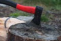 Axe in billets, chainsaw lying on a log Royalty Free Stock Photo