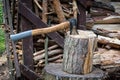 An axe driven into a stump. Preparing firewood. Chopping wood on a stump