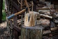 An axe driven into a stump. Preparing firewood. Chopping wood on a stump