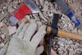 Axe, gloves and construction tools on pile of rubble Royalty Free Stock Photo