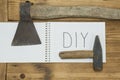 An axe and a hammer on his jeans and a white notebook on the top Royalty Free Stock Photo