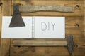 An axe and a hammer on his jeans and a white notebook on the top Royalty Free Stock Photo
