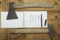 An axe and a hammer on his jeans and a white notebook on the top Royalty Free Stock Photo