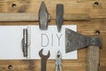 An axe and a hammer on his jeans and a white notebook on the top Royalty Free Stock Photo