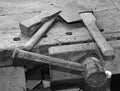 axe and hammer on the old wooden workbench and old balck and whi