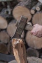 Heap of chopped wood, close up on the axe, cutting firewood and preparing winter wood