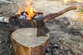 The Axe In The Log And Wood Against Grill Fire For Cooking BBQ Meat. Outdoor Picnic