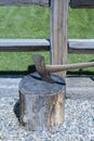 Axe is placed in an old chopping block made of a cut log. Royalty Free Stock Photo