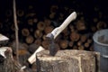 The axe is stuck in a log near the woodpile Royalty Free Stock Photo