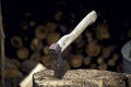 The axe is stuck in a log near the woodpile Royalty Free Stock Photo