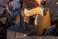 Axe stuck in a log in the yard about a woodpile on the street Royalty Free Stock Photo