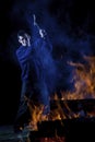 Axe wielding maniac by a fire Royalty Free Stock Photo
