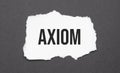 axiom sign on the torn paper on the black background