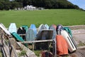 AXMOUTH, DEVON,ENGLAND - JULY 12TH 2020: Upturned rowing boats by the side of the river Axe at Axmouth Royalty Free Stock Photo