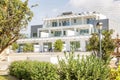 Ayia Napa, Cyprus, 09/02/2018: Beautiful large white house in greenery in a southern resort. A clear sunny day
