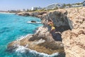 Ayia Napa, Greece - July 19, 2016: Summer fun, Friends cliff jumping into the ocean Royalty Free Stock Photo