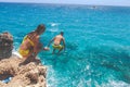 Ayia Napa, Greece - July 19, 2016: Summer fun, Friends cliff jumping into the ocean Royalty Free Stock Photo