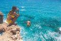 Ayia Napa, Greece - July 19, 2016: Summer fun, Friends cliff jumping into the ocean Royalty Free Stock Photo