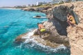 Ayia Napa, Greece - July 19, 2016: Summer fun, Friends cliff jumping into the ocean Royalty Free Stock Photo