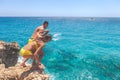 Ayia Napa, Greece - July 19, 2016: Summer fun, Friends cliff jumping into the ocean Royalty Free Stock Photo