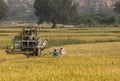 Small Claas pick thresher in rice field, Ayodhya, Karnataka, India