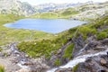 Ayous lake and a waterfall in summer in Pyrenees Royalty Free Stock Photo