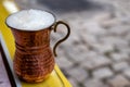 Ayran, traditional Turkish yoghurt drink buttermilk with foam served in traditional copper cup in Turkey