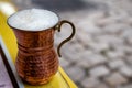 Ayran, traditional Turkish yoghurt drink buttermilk with foam served in traditional copper cup in Turkey