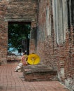 Beautiful Thai girl in traditional dress custume sit rest at Wat Ratchaburana