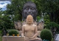 Buddha statue and Head of the big black bronze buddha statue in the lotus flower closeup. Ancient sculpture in the buddhist temple