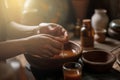 An Ayurvedic abhyanga massage in progress, showing hands rhythmically prepare herbal oils to a warm skin. Capture the rejuvenating