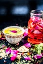 Ayurvedic face pack of dried grounded leaves of Indian iliac or neem with gram flour and rose water with some rose petals on woode