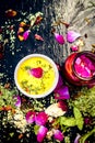 Ayurvedic face pack of dried grounded leaves of Indian iliac or neem with gram flour and rose water with some rose petals on woode