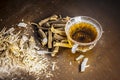 Famous herb Licorice root or Liquorice root or Mulethi root on wooden surface along with its beneficial tea in a transparent cup.