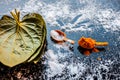 Ayurvedic remedy for sour throat consisting of betel leaves, turmeric, and salt on a black wooden surface.