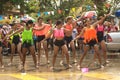 Group of dancer playfully and dancing splashing water on a street.