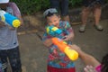 A boy play and enjoy water spraying with plastic gun. Join in on the Songkran Festival. Royalty Free Stock Photo