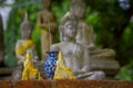 AYUTTHAYA, THAILAND, FEBRUARY, 08, 2018: Close up of small budhas inside of plastic bag with huge Ancient Buddha Statue