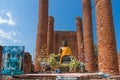 Old ruins of  Wat Thammikarat temple with sitting Buddha statue Royalty Free Stock Photo