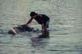 AYUTTHAYA, THAILAND - JANUARY 2019: Trainers bathing elephantsin river in evening and playing with the elephant hidden place Royalty Free Stock Photo