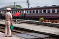 Ayutthaya,Thailand-November 01 2017 :Train staff Make a signal with red flag to people that train arrives