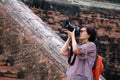 Women tourists taking pictures and background ancient brick at Yai Chaimongkol Temple, Thailand Royalty Free Stock Photo