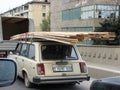 Azerbaijan, Baku - April 27, 20107: Classic soviet vintage sedan car LADA VAS with trunk that is overload by wooden boards