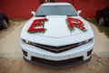 Decorated with flowers as for a wedding . Fresh flowers on the car. Beautiful wedding bouquet on white wedding car . Beautiful Royalty Free Stock Photo