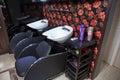 Barbershop washbasin with professional chairs . Beauty salon interior - a row of hair washing sinks - white washbasins for Royalty Free Stock Photo