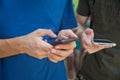 Boy holding telephone in hand . He has a white Samsung phone in his hand . Royalty Free Stock Photo