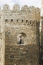 Azerbaijan, Baku-March 11, 2018; a Young girl poses in the castle tower of an ancient city. A young girl in the window of the cast Royalty Free Stock Photo