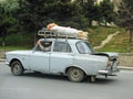 Azerbaijan, Baku - May 12, 20107: Classic soviet vintage sedan car Moskvich with trunk that is overload by sacks with vegetables