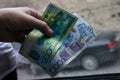 Azerbaijan, Baku - Nowember 2009: Man hand with manat isolated on black background, Hand holding out a fan of tenges of Royalty Free Stock Photo